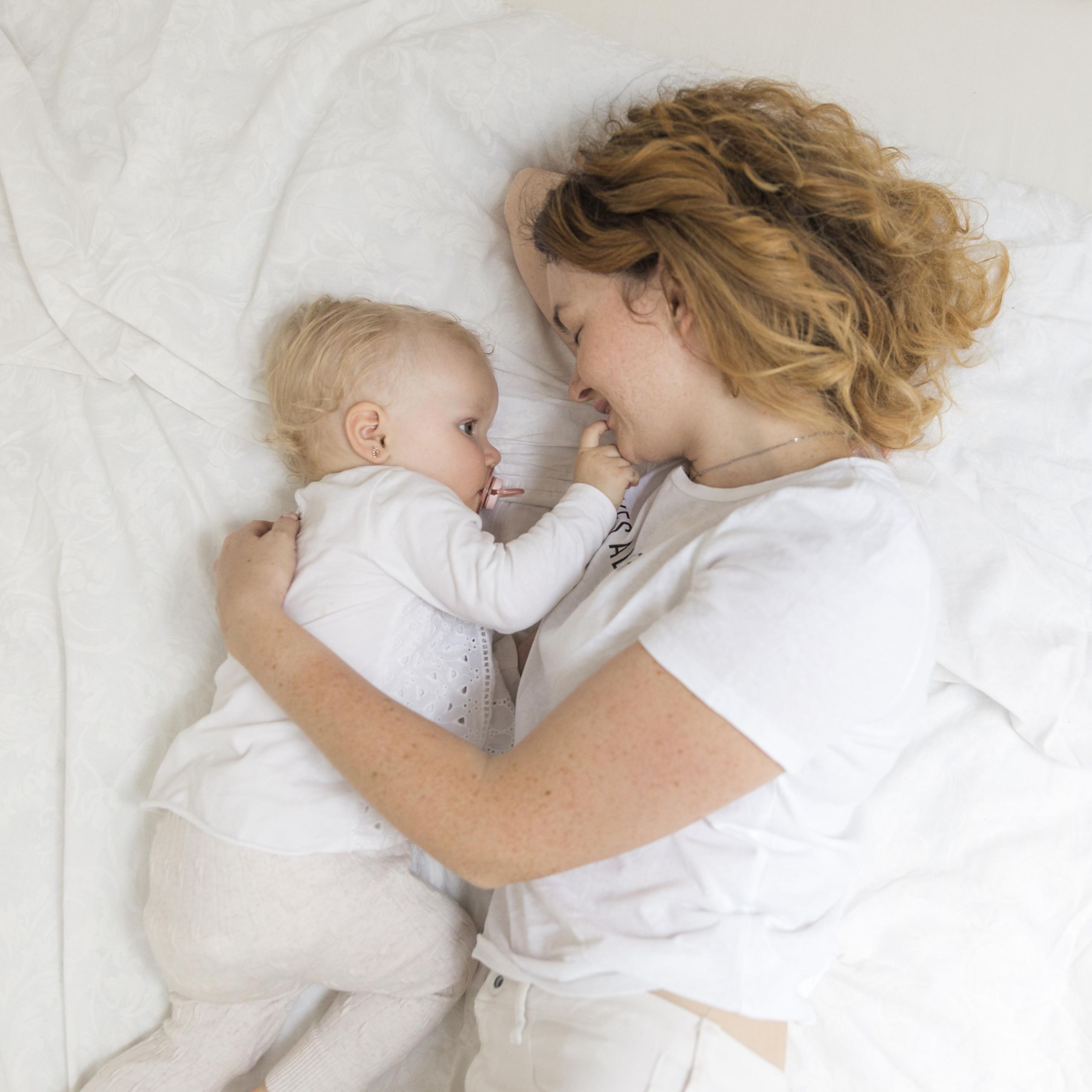 top-view-mother-hugging-her-baby-girl